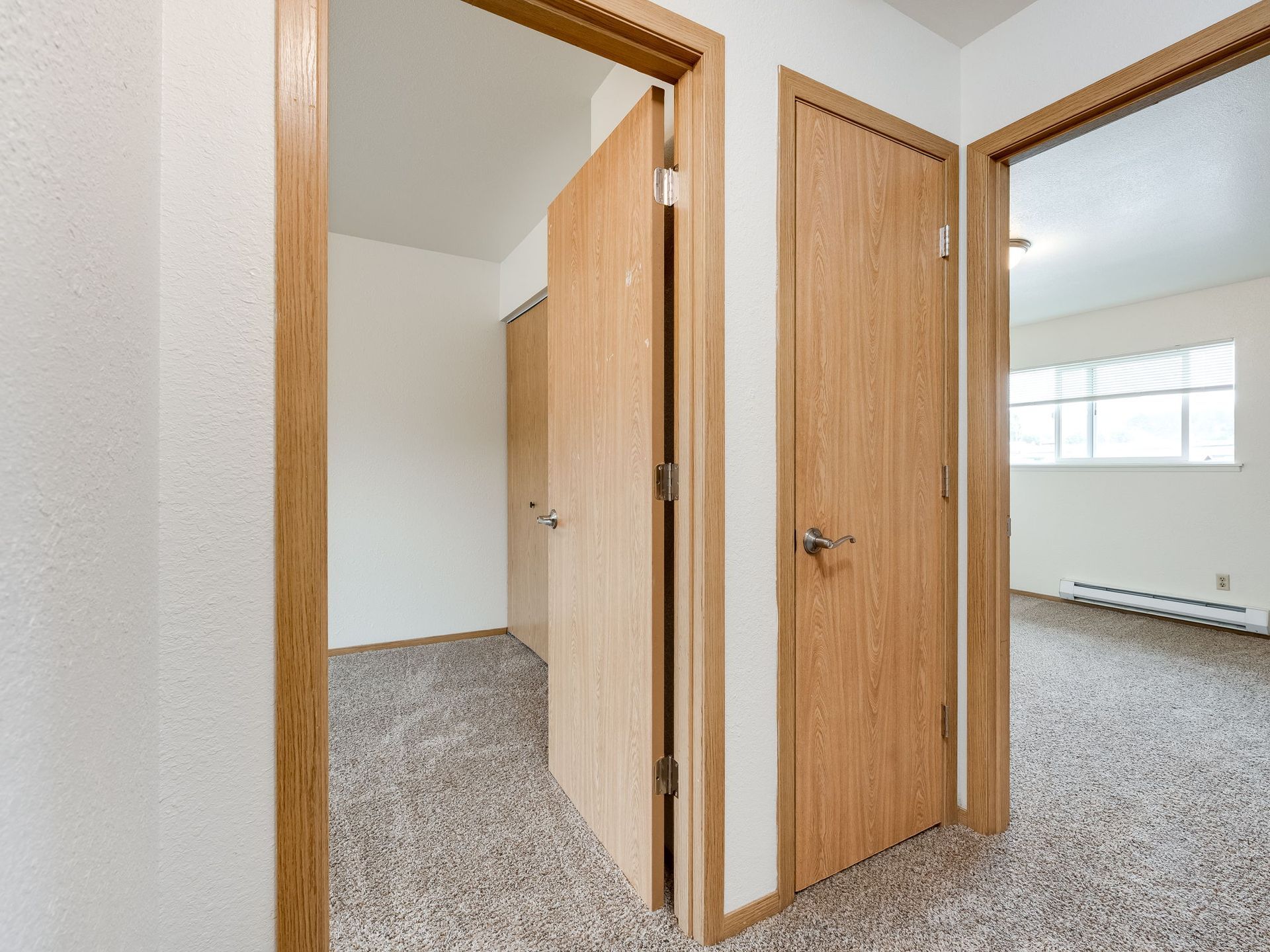 Southridge Apartments Townhome upstairs hallway looking into  both bedrooms.