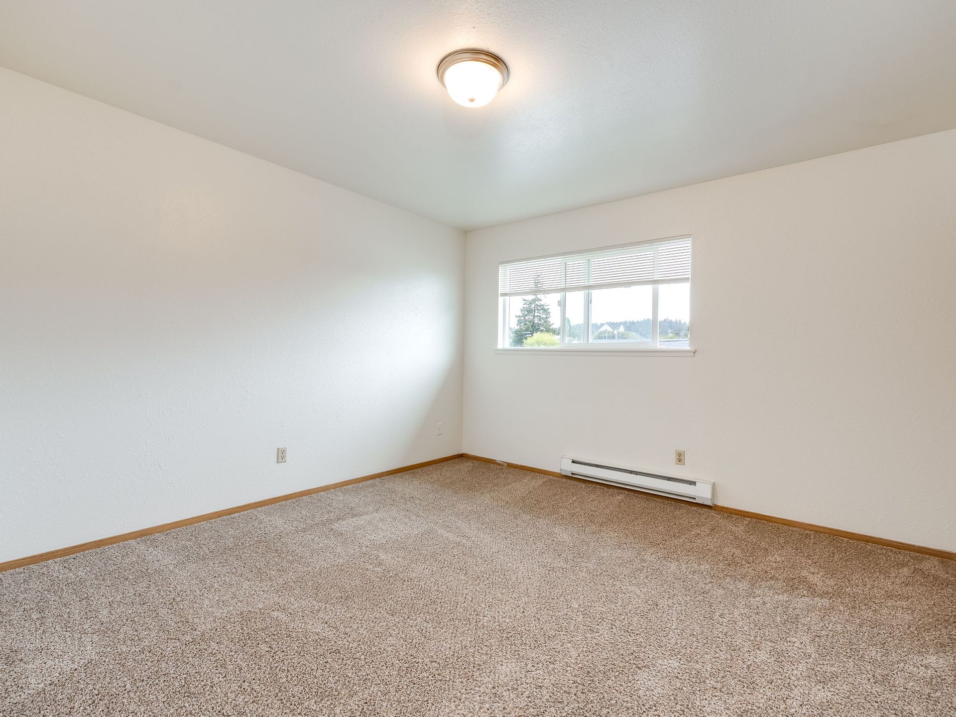 Southridge Apartments Townhome bedroom 1 with view of window.