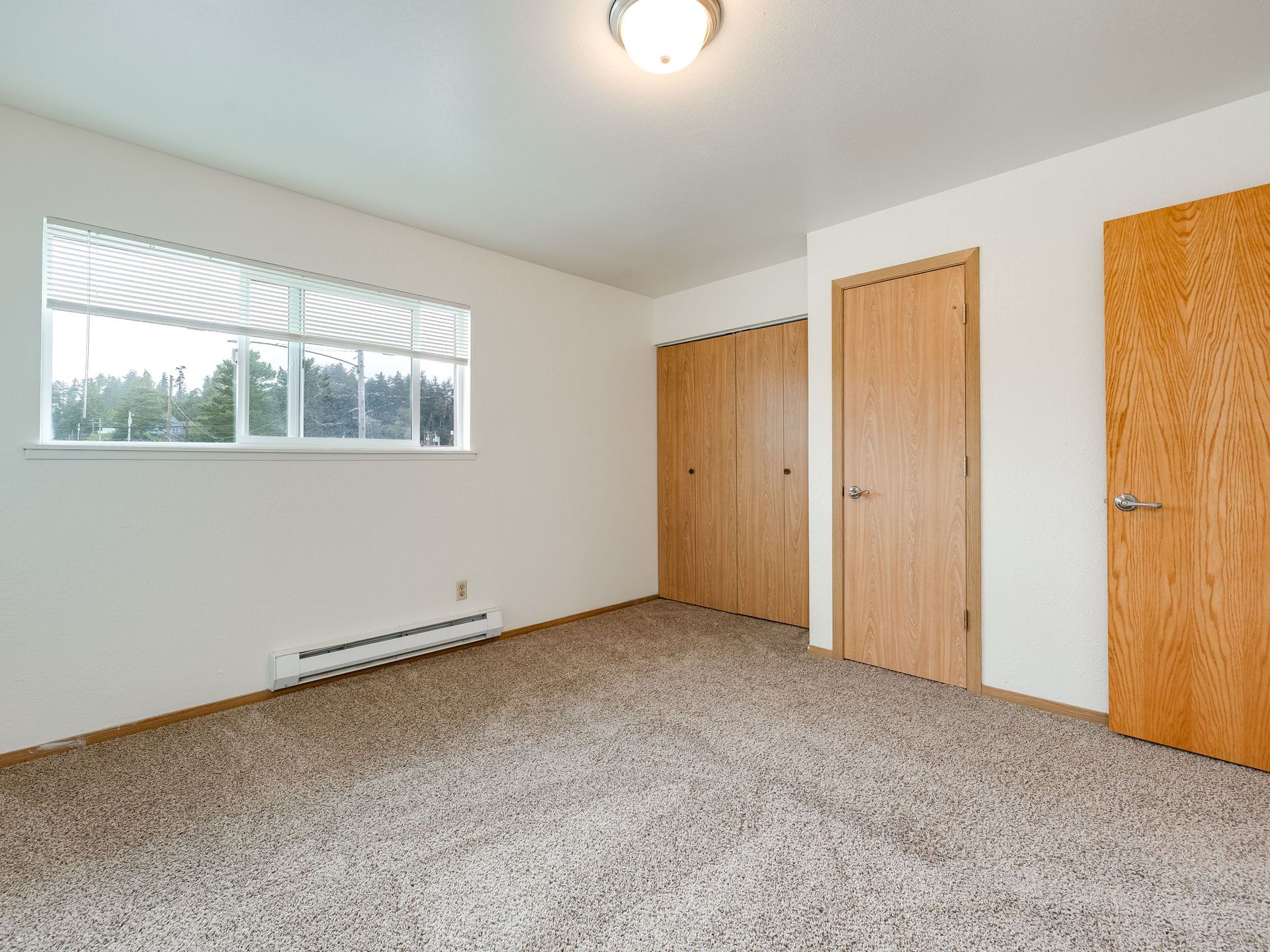 Southridge Apartments Townhome bedroom 1 with view of window and closet.