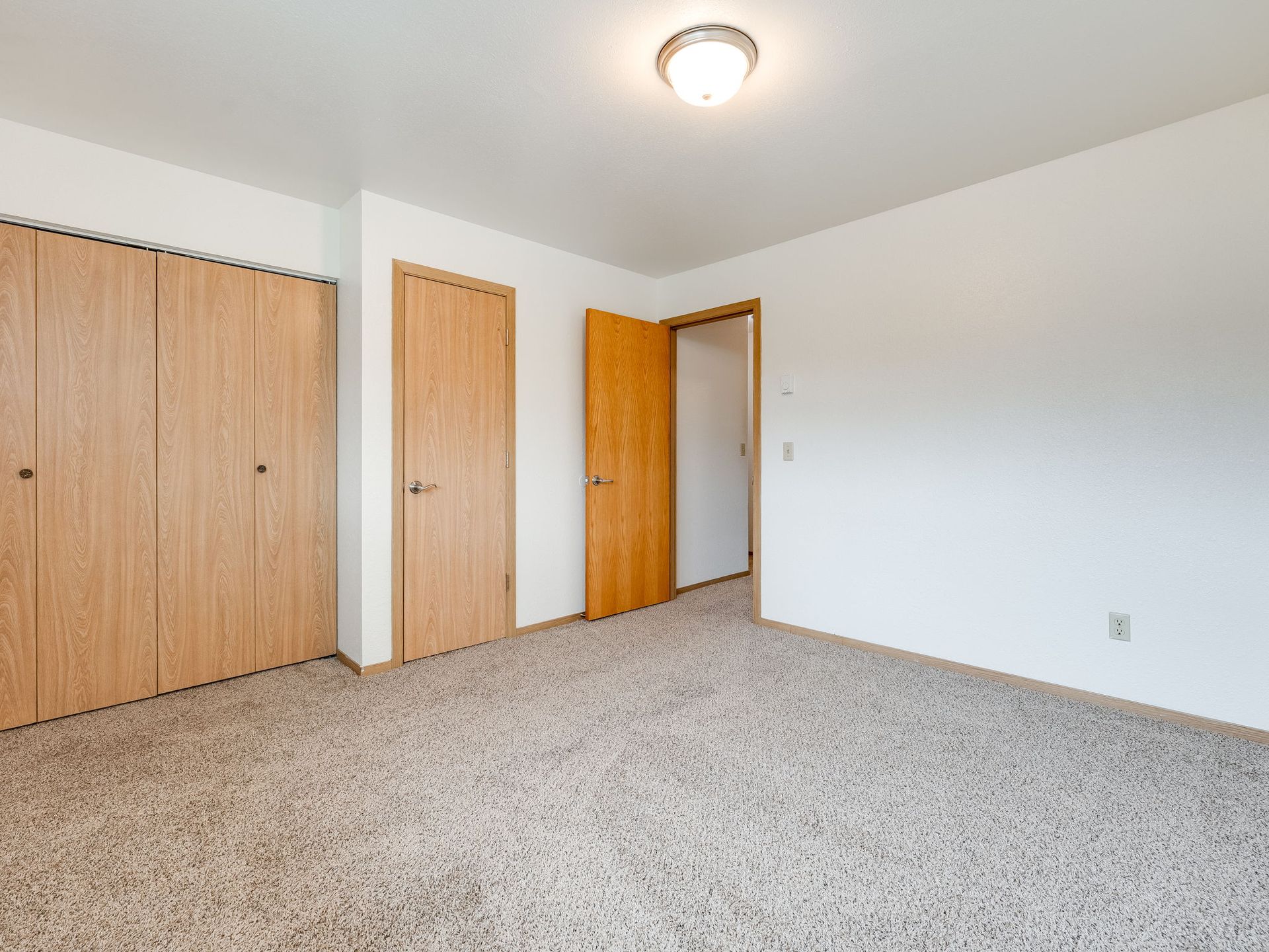 Southridge Apartments Townhome bedroom 1 with view of closet and door.