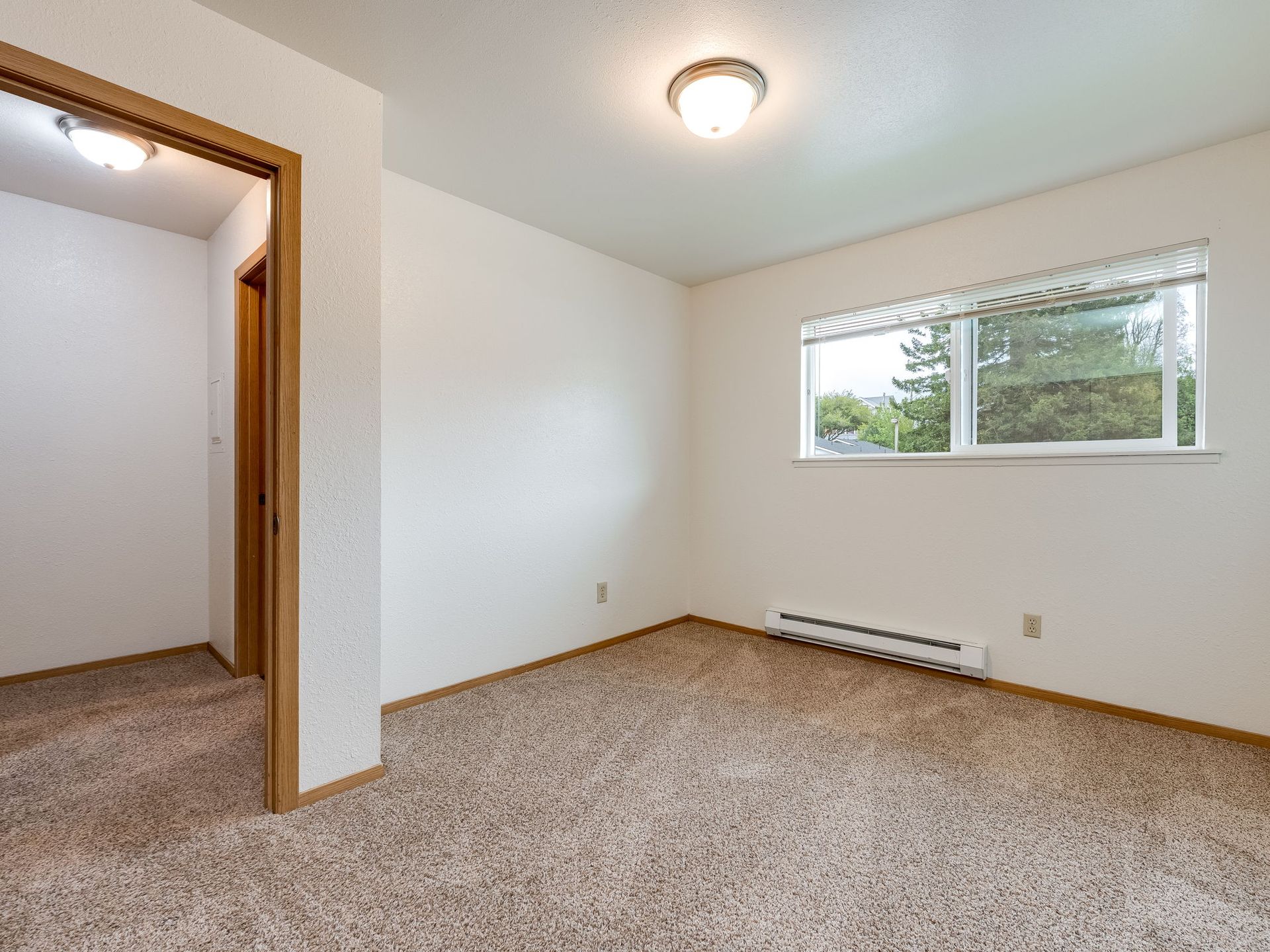 Southridge Apartments Townhome bedroom 2 with view of door and window.