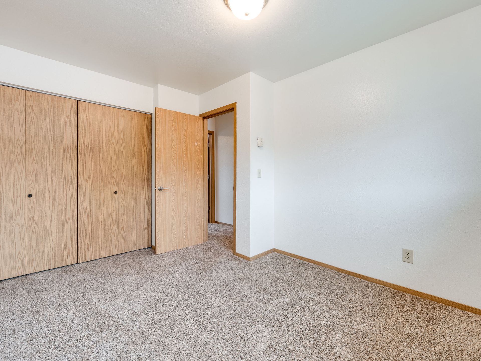 Southridge Apartments Townhome bedroom 1 with view of window with view of door and closet.