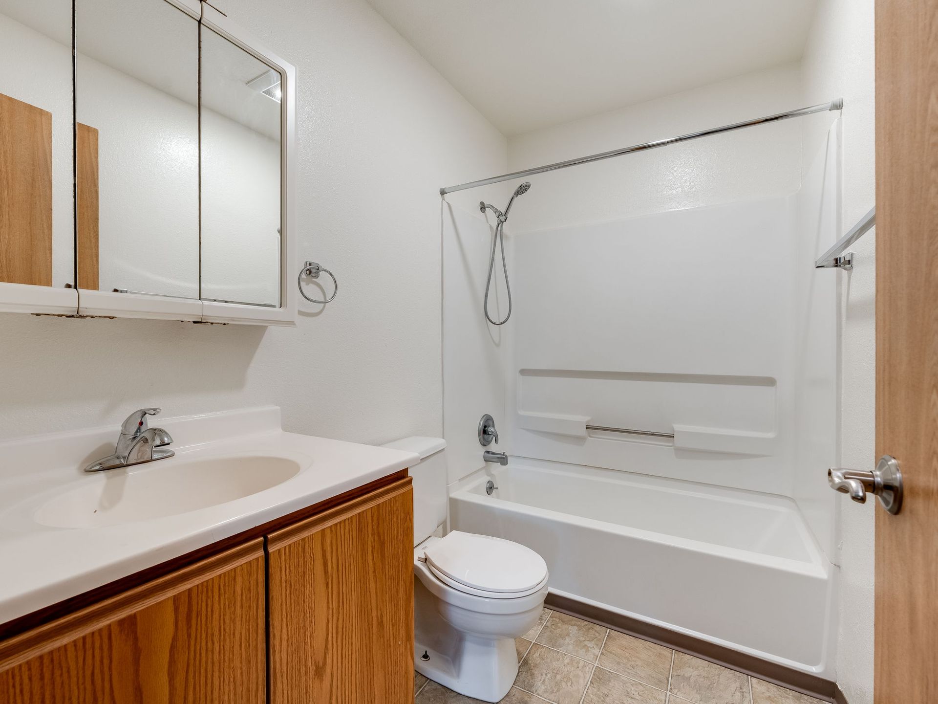 Southridge Apartments Townhome bathroom with view of vanity, toilet and tub.