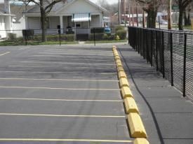 A Parking Lot With Yellow Curbs And A Fence | Manilla, IN | Floyd Crim & Sons Paving