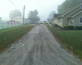 A Dirt Road Leading To A House On A Foggy Day | Manilla, IN | Floyd Crim & Sons Paving