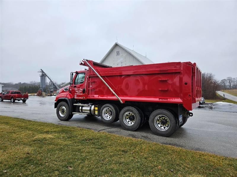 A Red Dump Truck Is Parked On The Side Of The Road In Front Of A Barn | Manilla, IN | Floyd Crim & Sons Paving