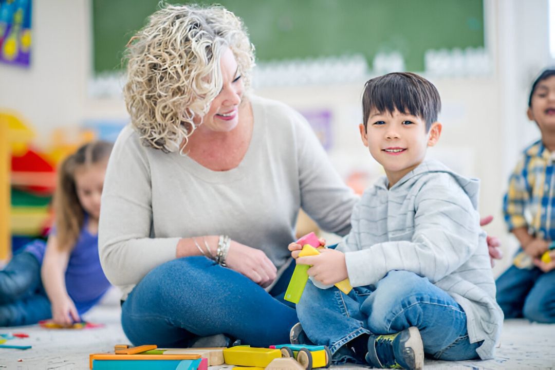 Person and a child sitting on the floor.