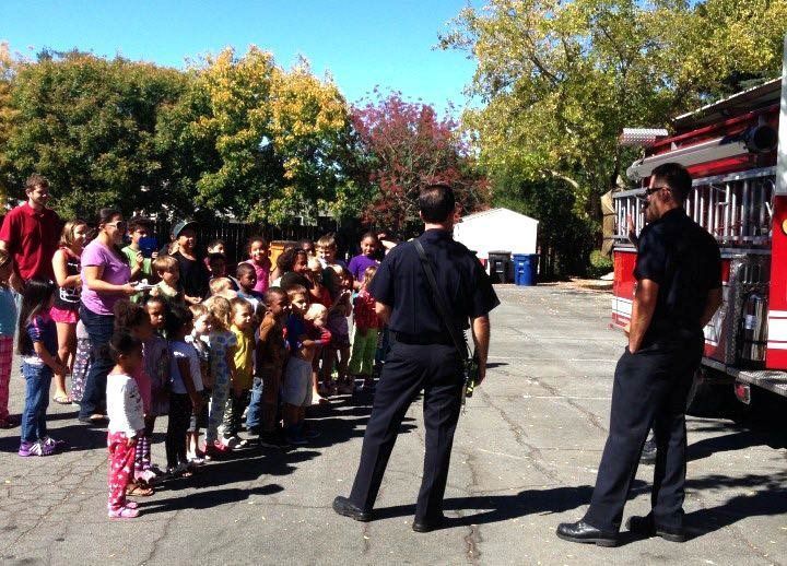 A group of people standing in front of a fire truck