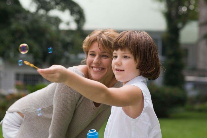 Mother and Daughter playing bubbles together  - Foster Care Training Process Cleveland