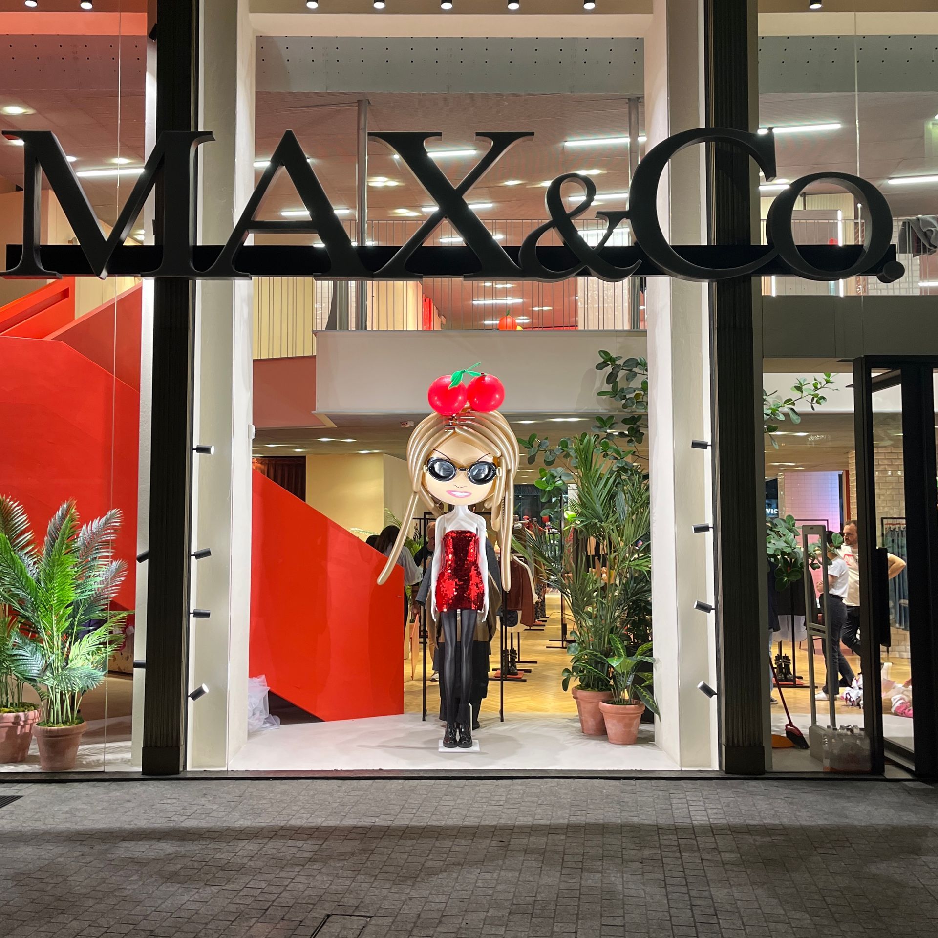 A max & co store with a mannequin in the window