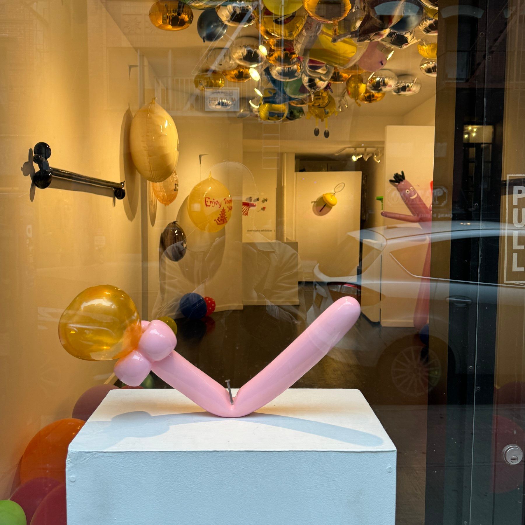 A display of balloons in a store with a sign that says ' a ' on it