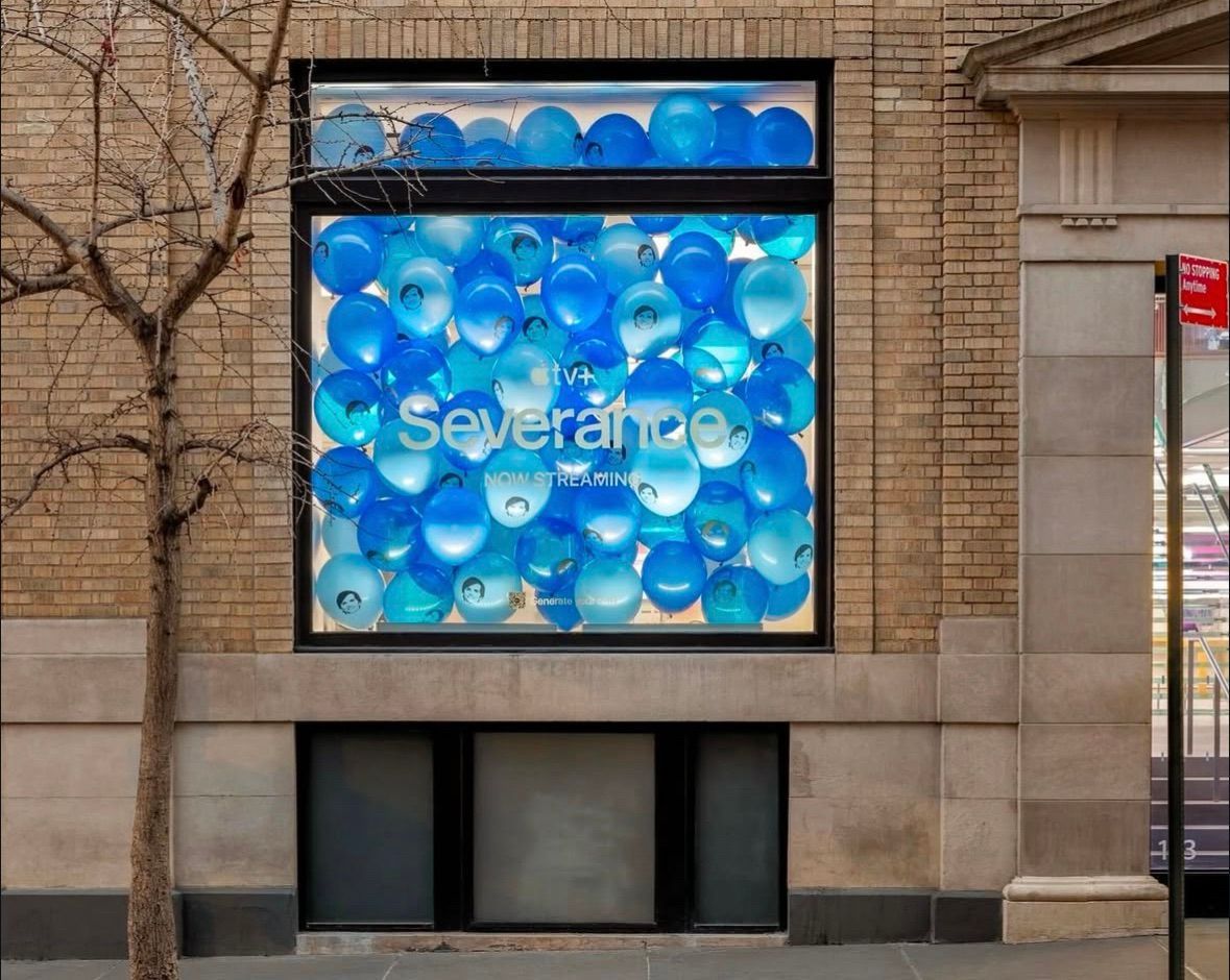 A window with blue balloons and the word severance on it