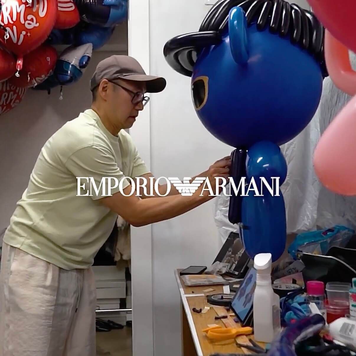 A man is working on a balloon for emporio armani