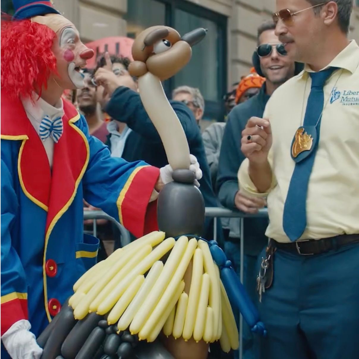 A man holding a blue balloon with a face on it