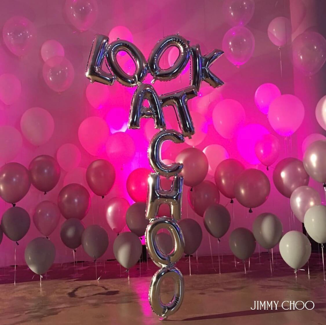 A balloon that says look at chicago is surrounded by pink balloons