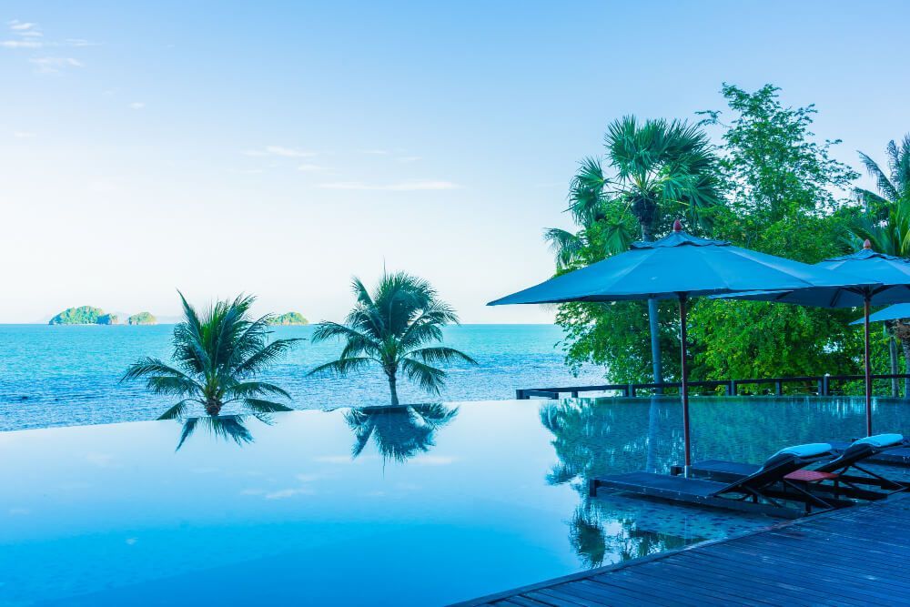 umbrella-chair-around-beautiful-luxury-outdoor-swimming-pool-with-sea-ocean-view-hotel-resort-holiday-vacation-travel (1)