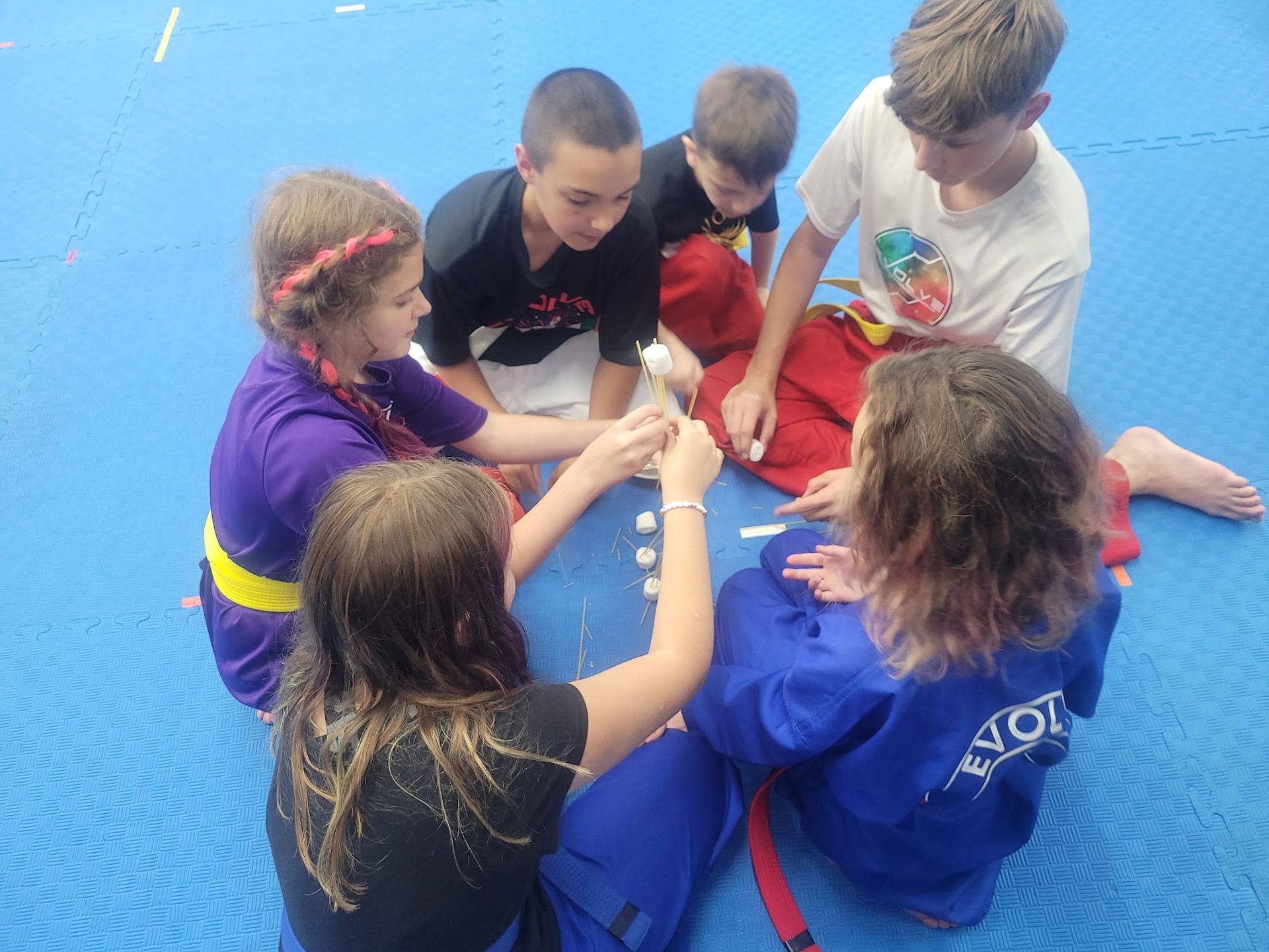 A person is holding a sparkler in their hand in the dark.