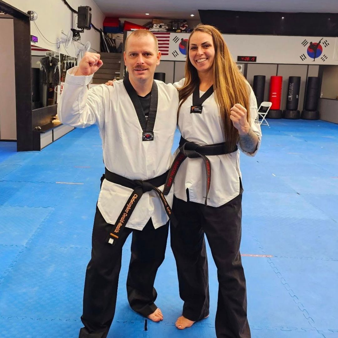 A group of men are practicing karate in a gym.