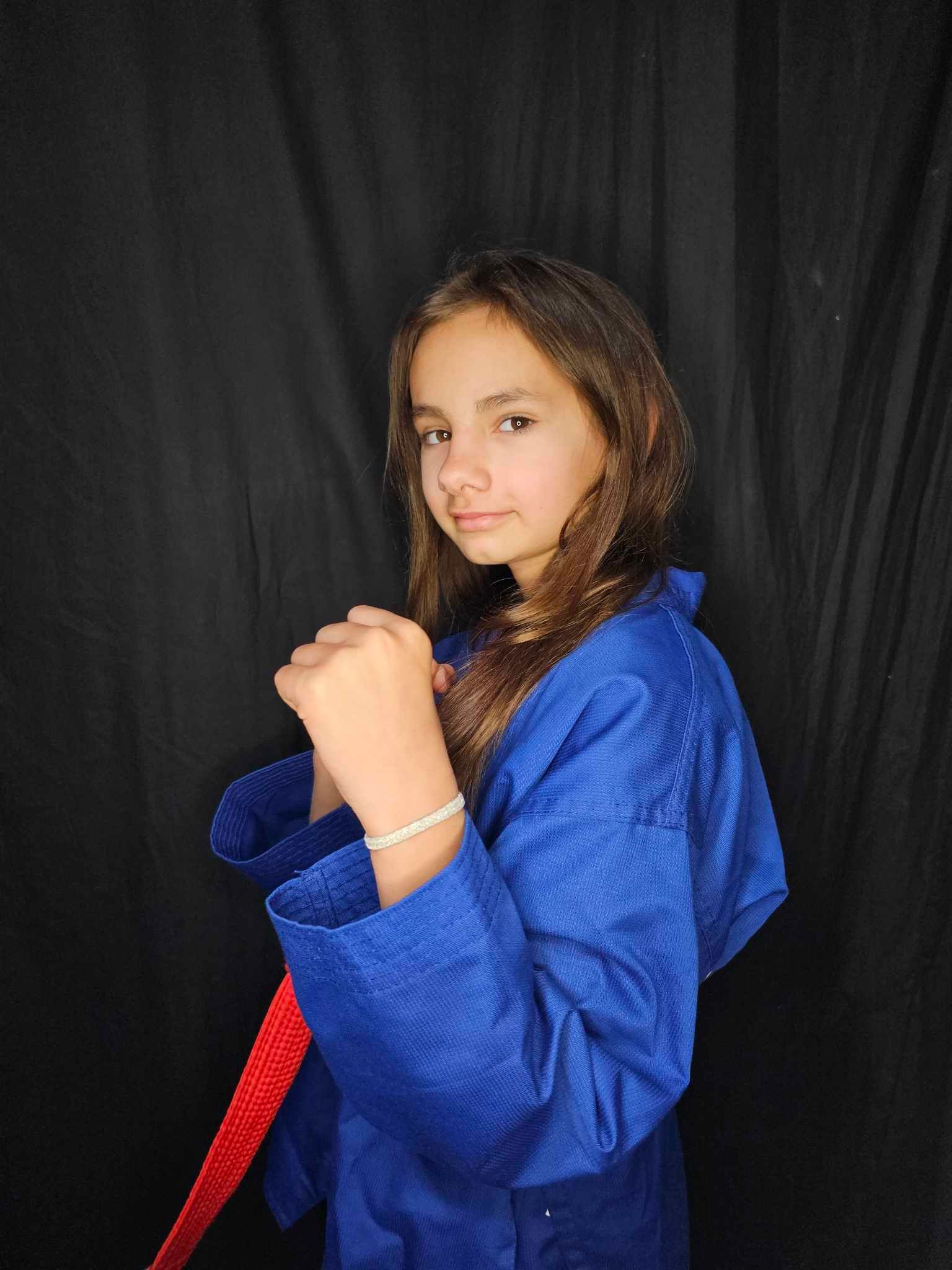 A person is holding a sparkler in their hand in the dark.