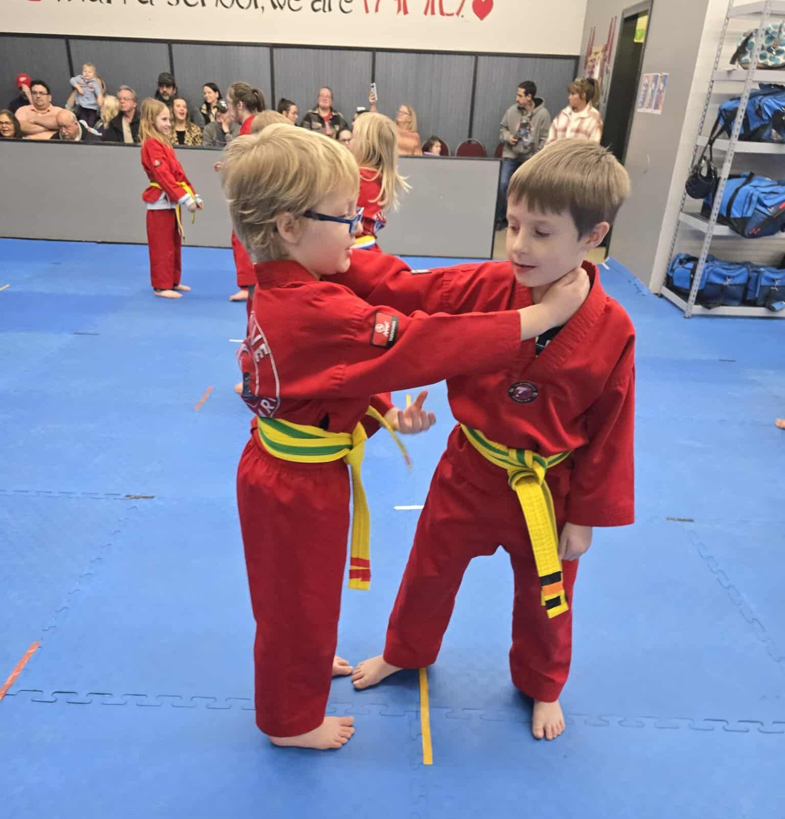 A young girl is practicing taekwondo in a gym.