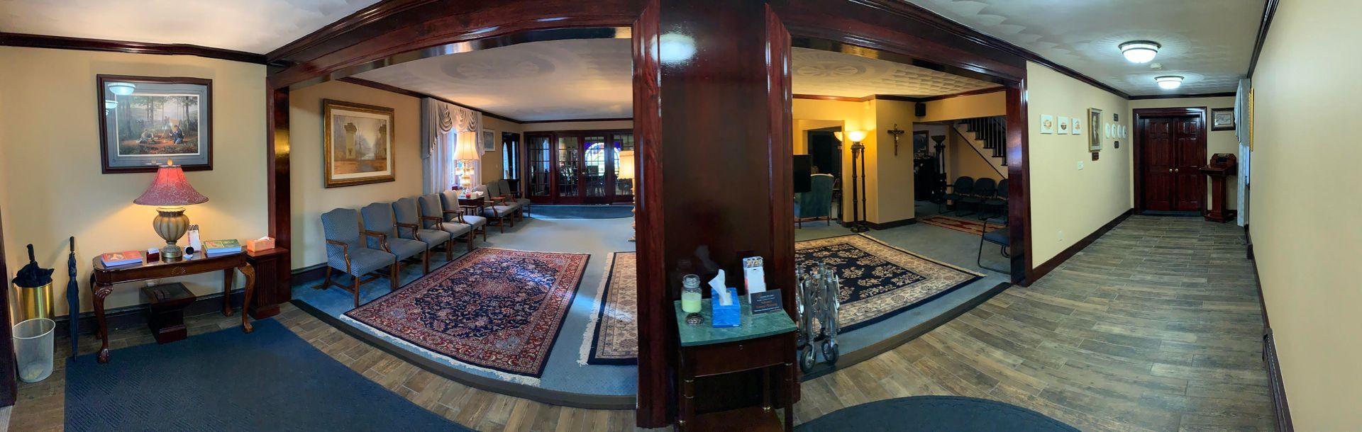 An artist 's impression of a hotel lobby with a couch , chairs , and plants.