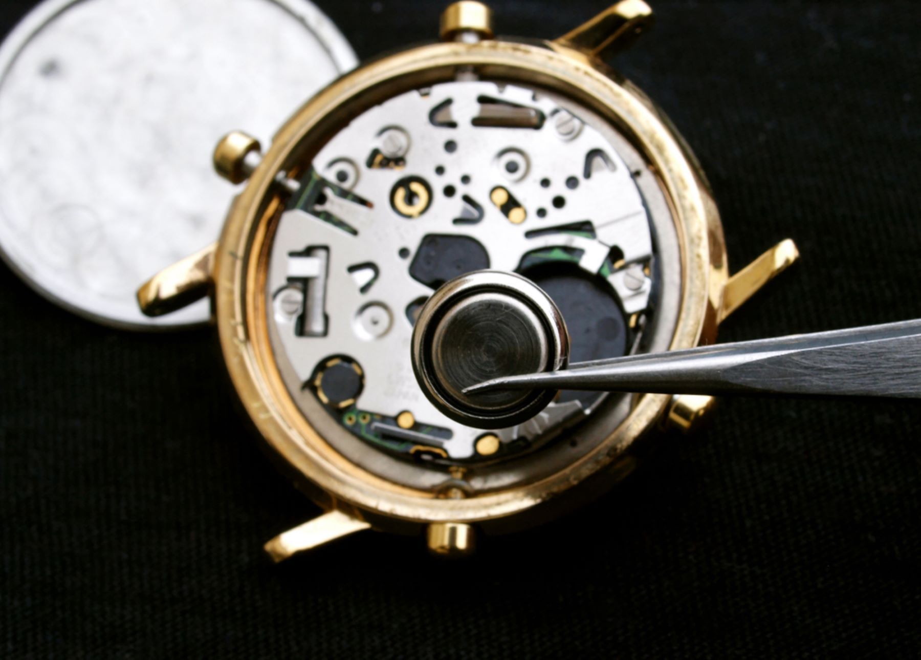 A Watch is Being Repaired With a Battery — Coastal Clocks & Watches in Buddina, QLD