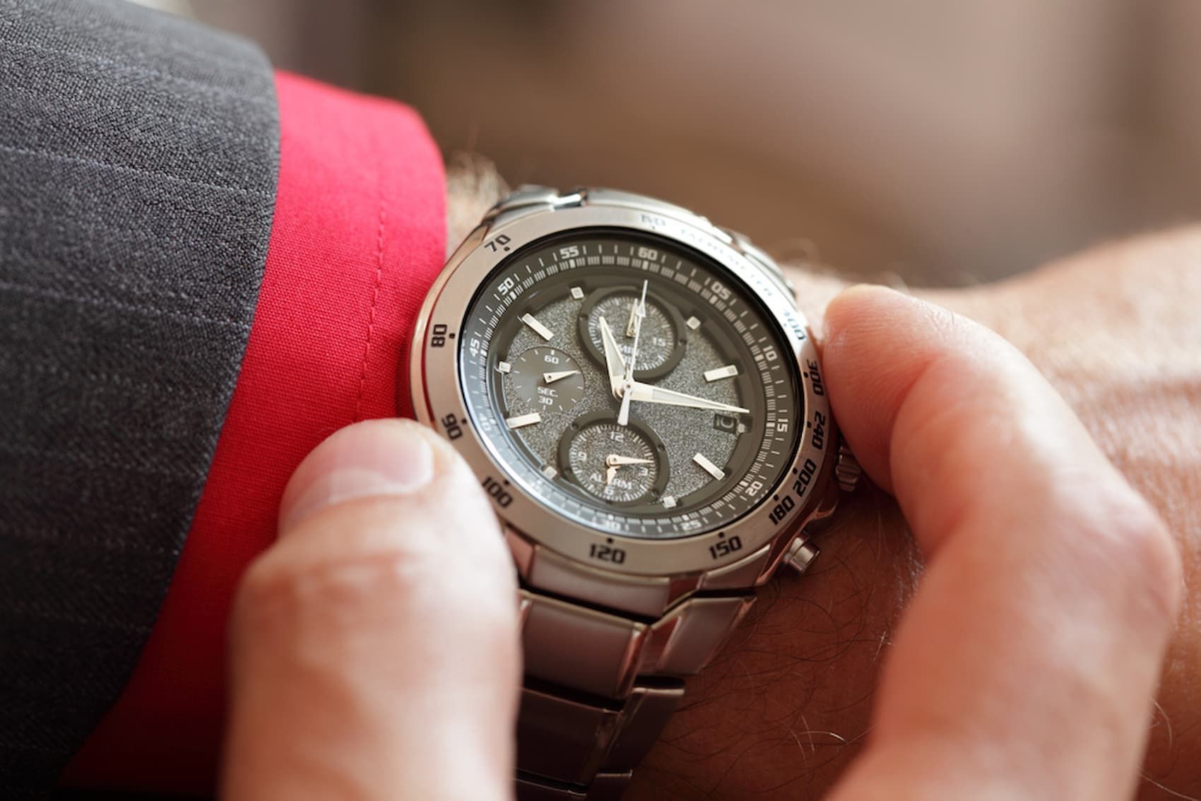 A Man Is Looking at His Watch on His Wrist — Coastal Clocks & Watches in Buddina, QLD
