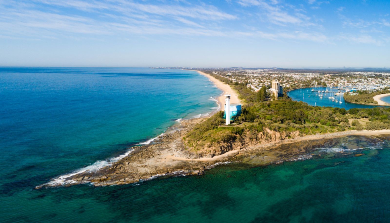An Aerial View of a Lighthouse on a Small Island in the Middle of the Ocean — Coastal Clocks & Watches in Mooloolaba, QLD