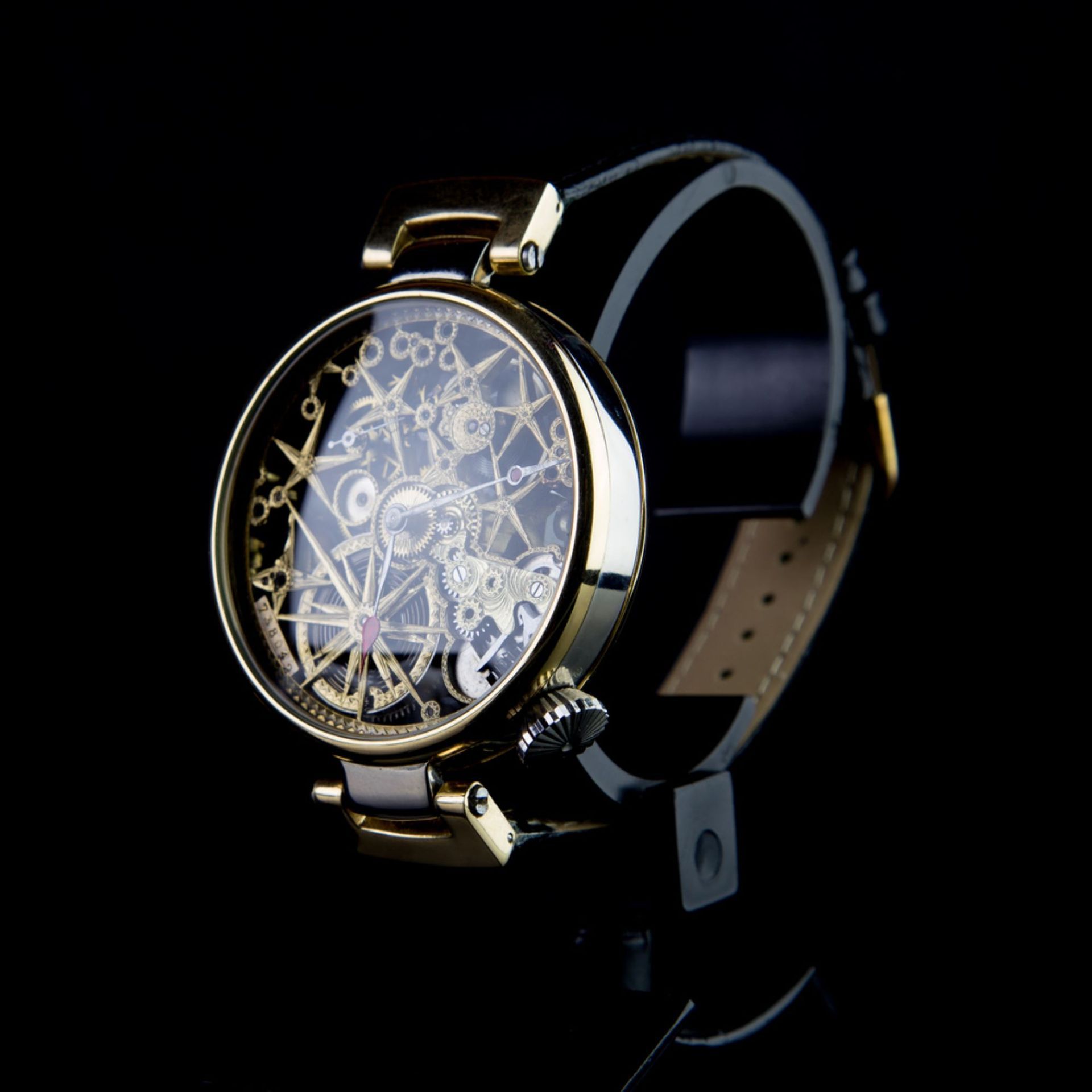 A Gold Watch With a Skeleton Face on a Black Background — Coastal Clocks & Watches in Mooloolaba, QLD