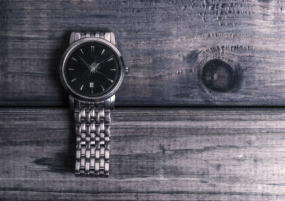 A Black and White Photo of a Watch on a Wooden Table — Coastal Clocks & Watches in Buddina, QLD