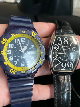 A Person is Holding Two Watches — Coastal Clocks & Watches in Buddina, QLD