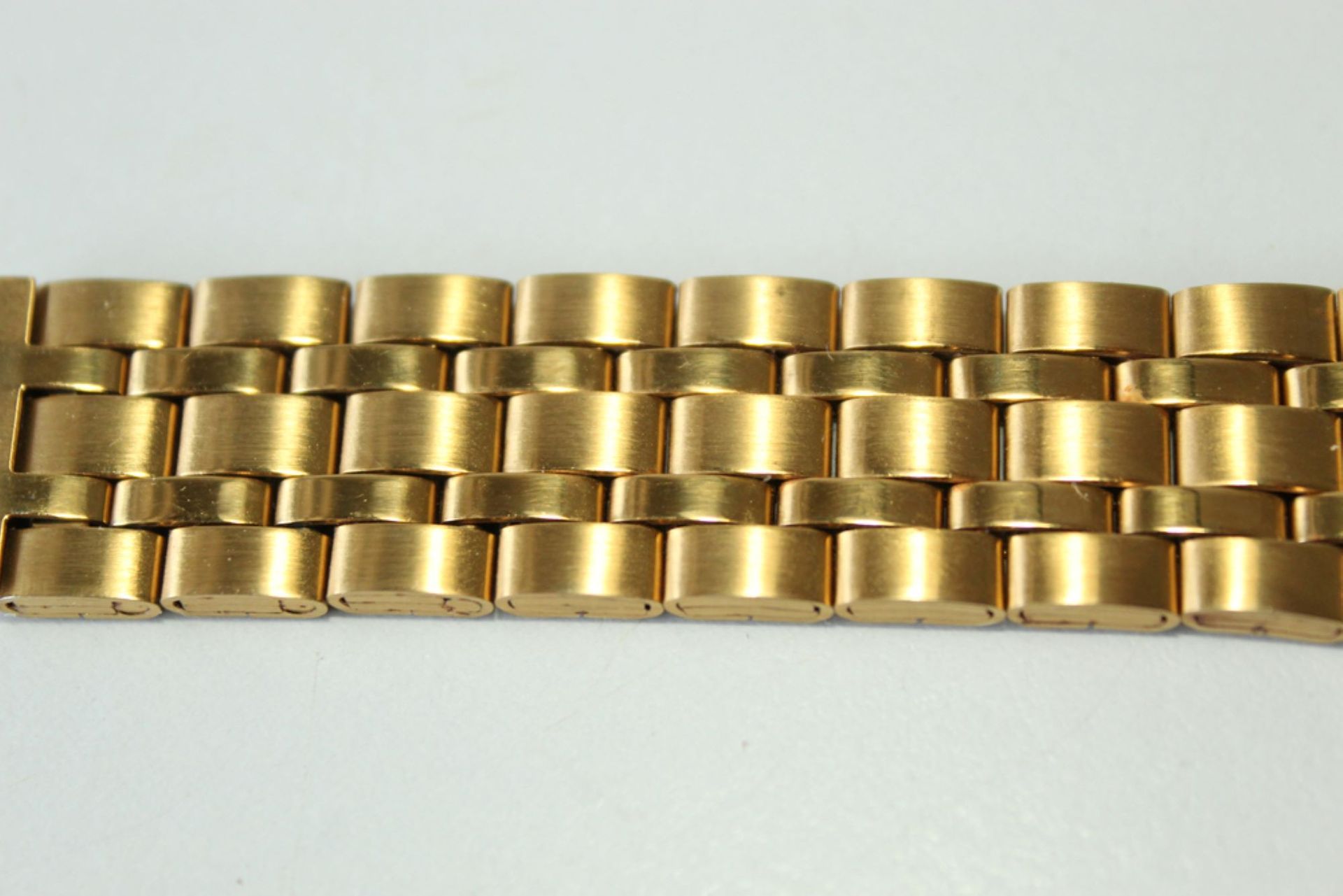 A Close Up of a Gold Watch Band on a White Surface — Coastal Clocks & Watches in Mooloolaba, QLD