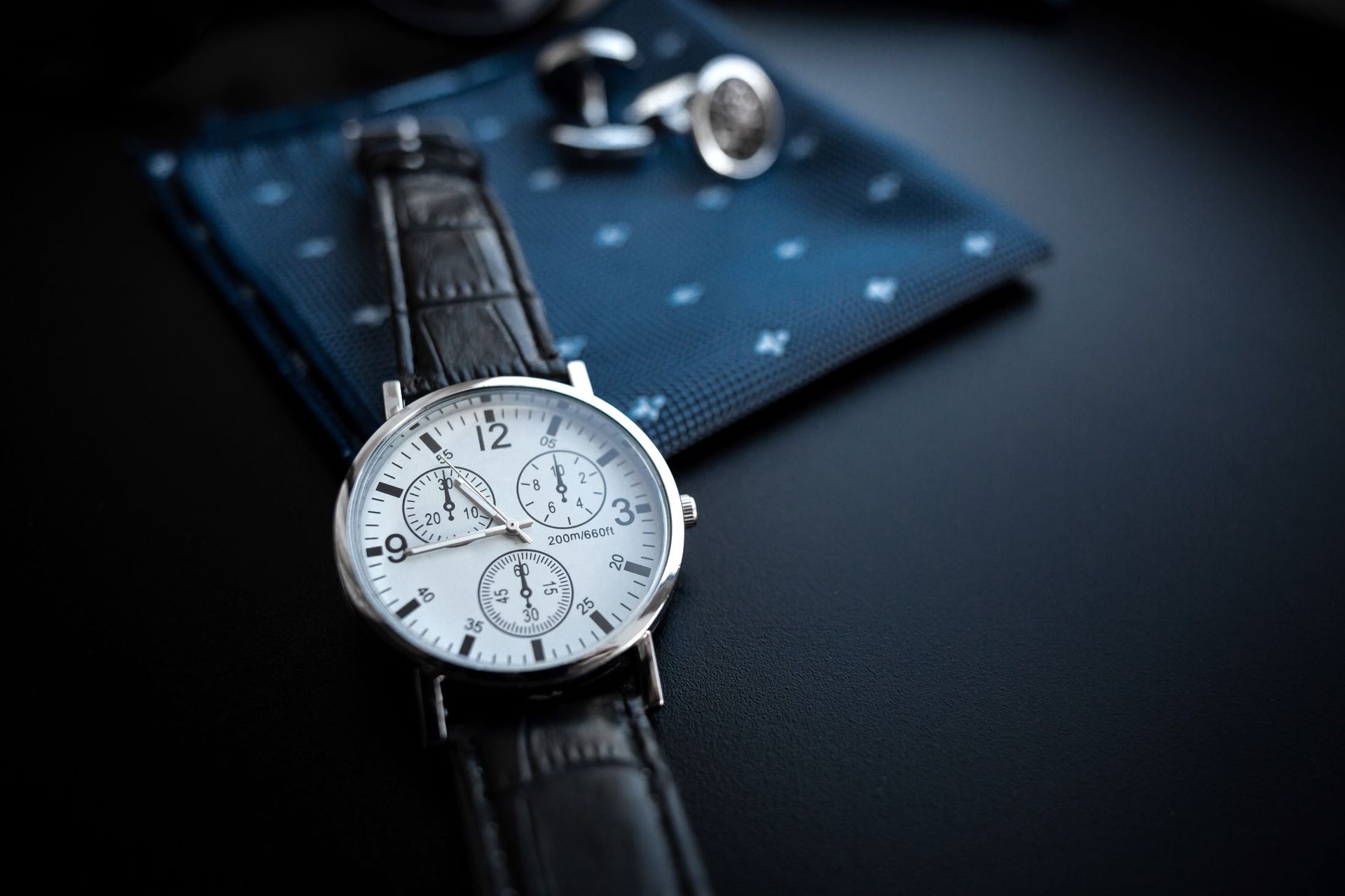 A Watch is Sitting on a Table Next to a Pocket Square and Cufflinks — Coastal Clocks & Watches in Buddina, QLD