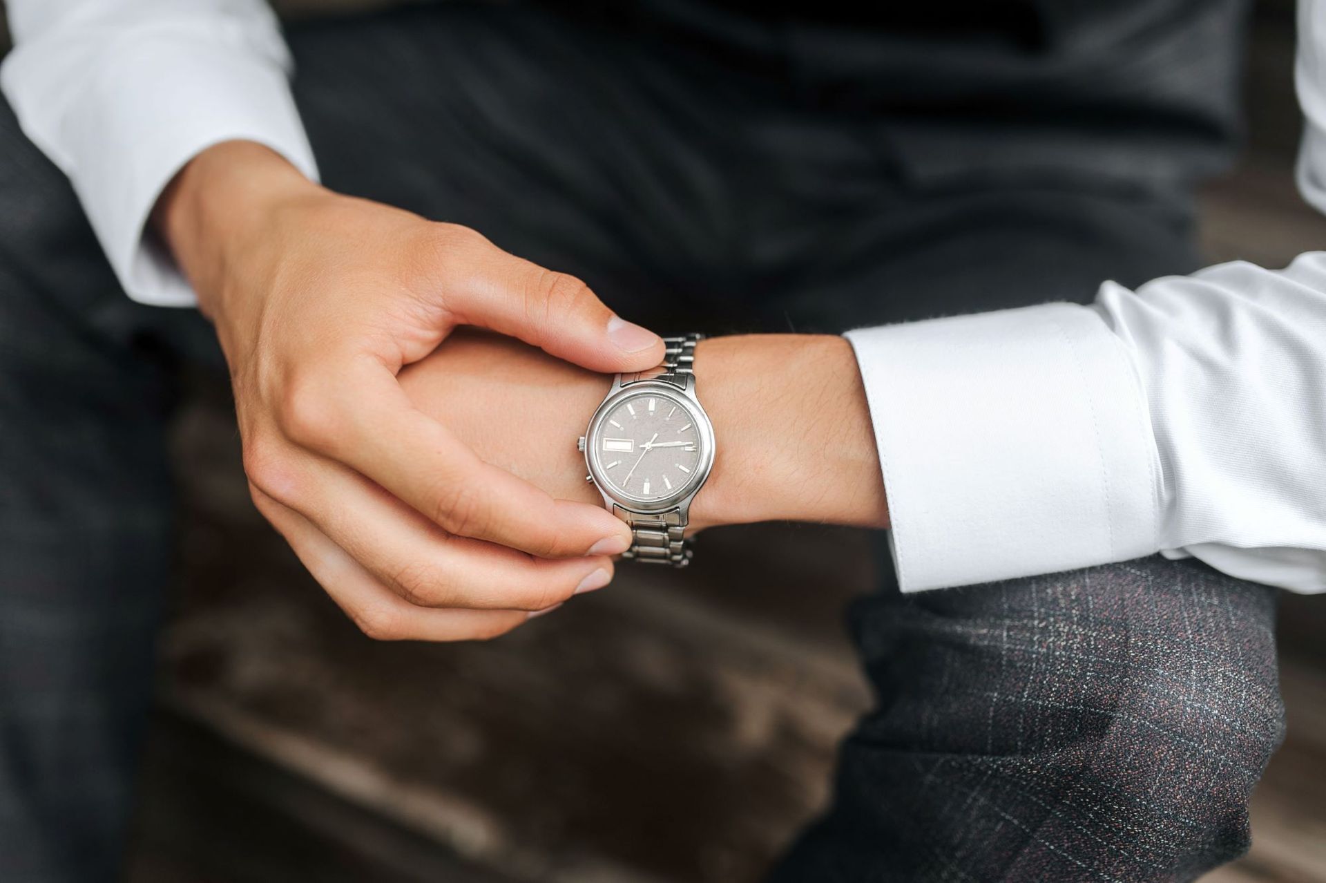 A Man is Wearing a Silver Watch on His Wrist — Coastal Clocks & Watches in Buddina, QLD