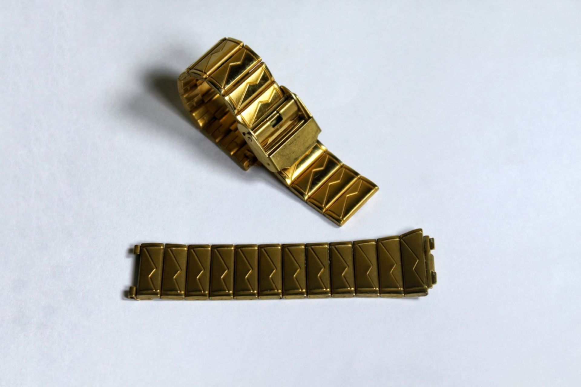 A Gold Watch Band is Laying on a White Surface — Coastal Clocks & Watches in Buddina, QLD