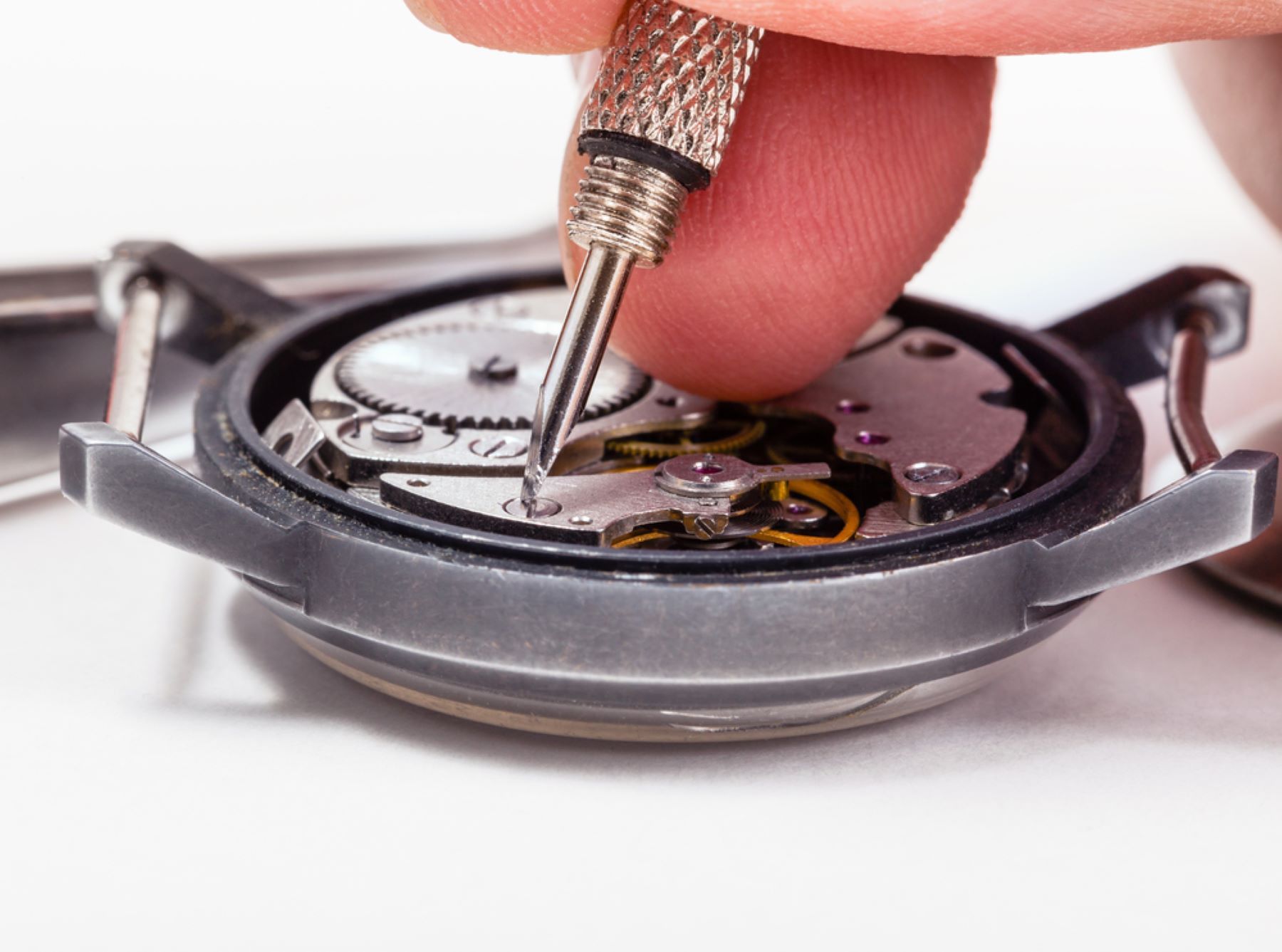 A Person is Fixing a Watch With a Screwdriver — Coastal Clocks & Watches in Mooloolaba, QLD