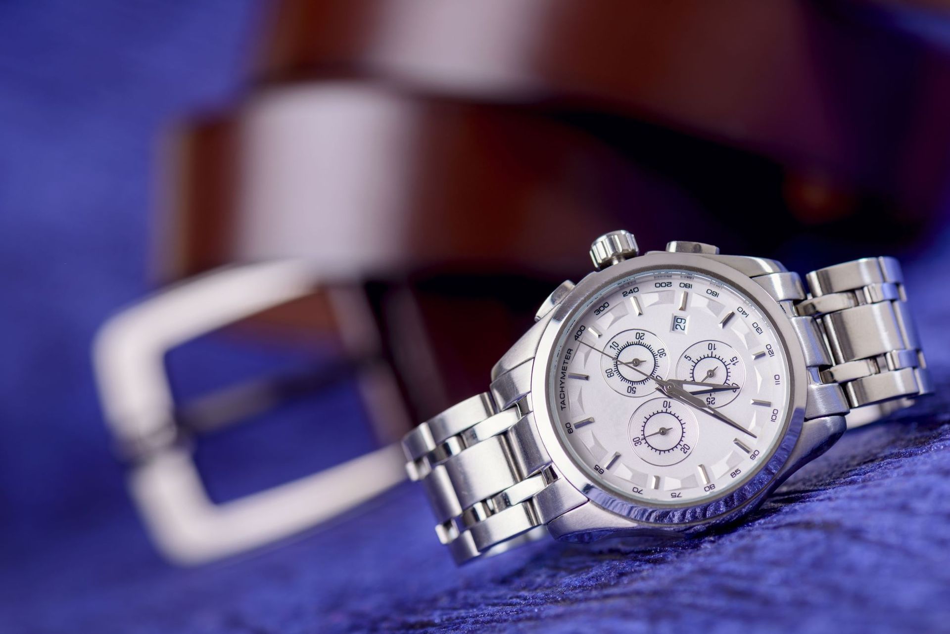A Silver Watch is Sitting on a Blue Surface — Coastal Clocks & Watches in Buddina, QLD