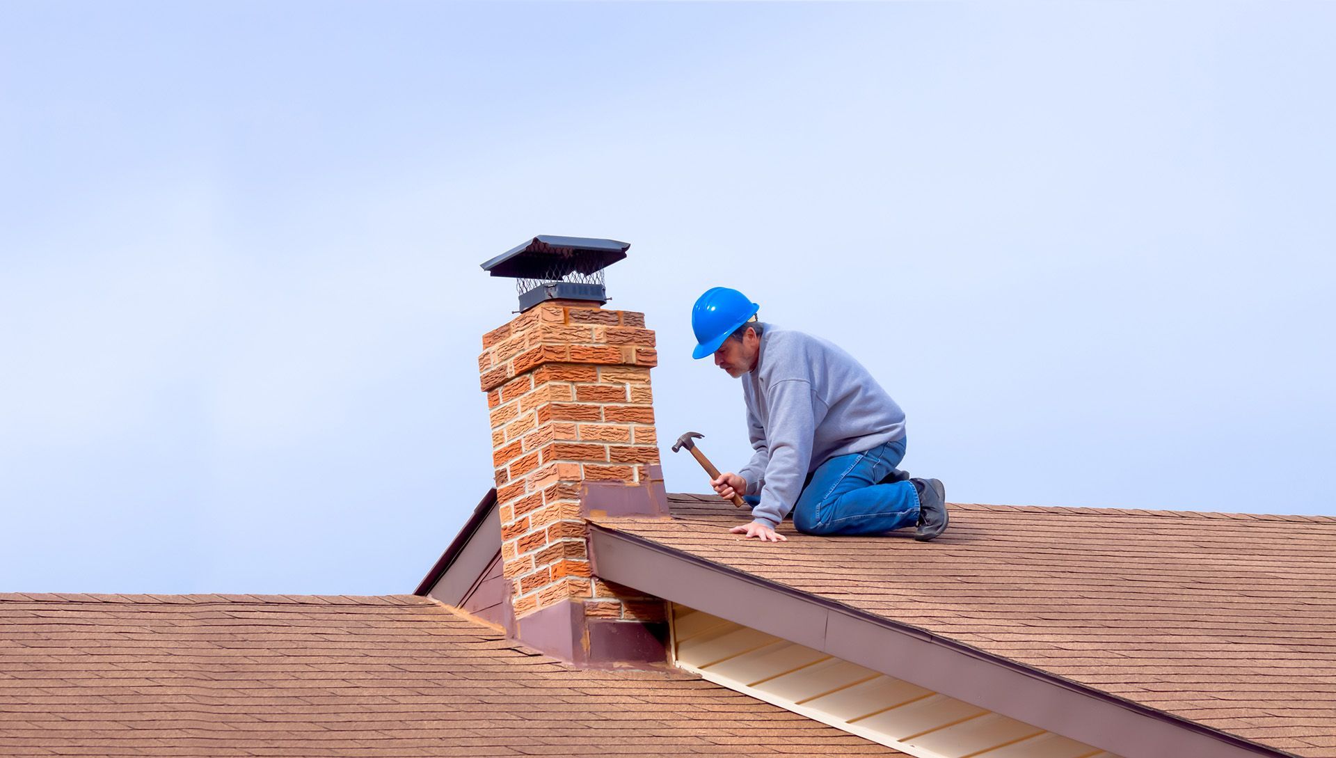 roofing contractor nailing in shingle roofing