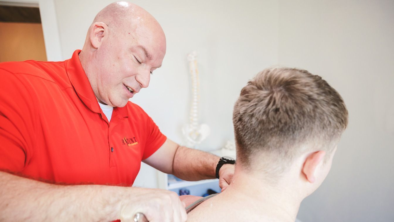 Chiropractor adjusting patient's neck.
