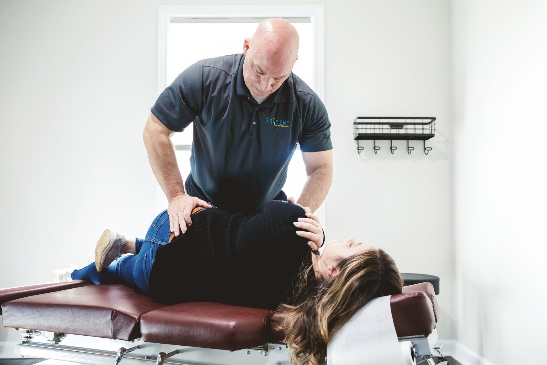 Chiropractor adjusting patient's neck.