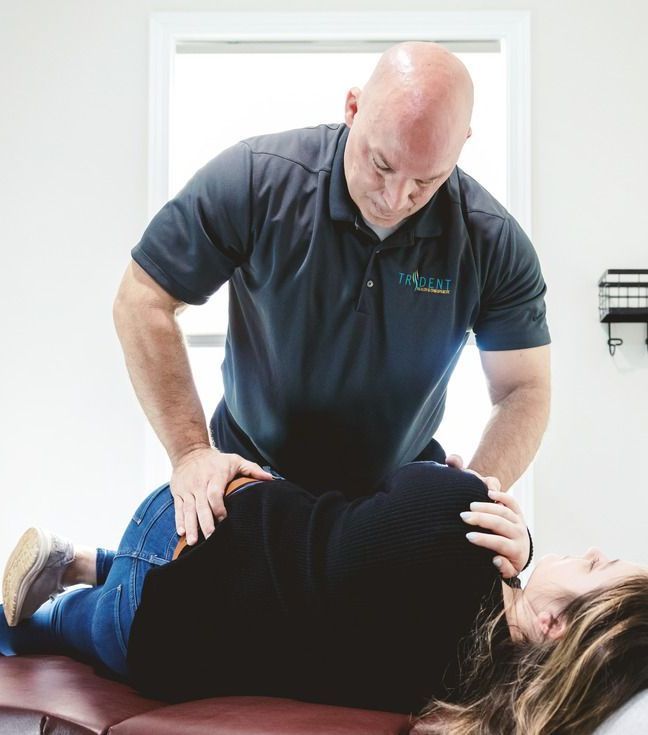 Chiropractor performing back adjustment.