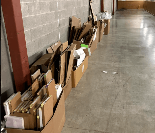 a Fleur de Lis junk removal customers hallway filled with cardboard boxes on the floor