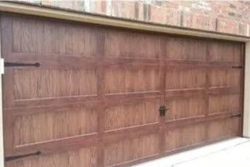 A Wooden Garage Door Is Sitting on The Side of A Building.