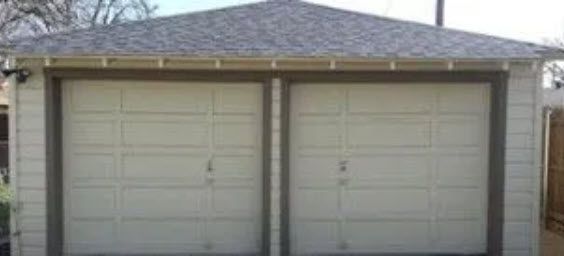 A Garage with Two Garage Doors and A Roof.