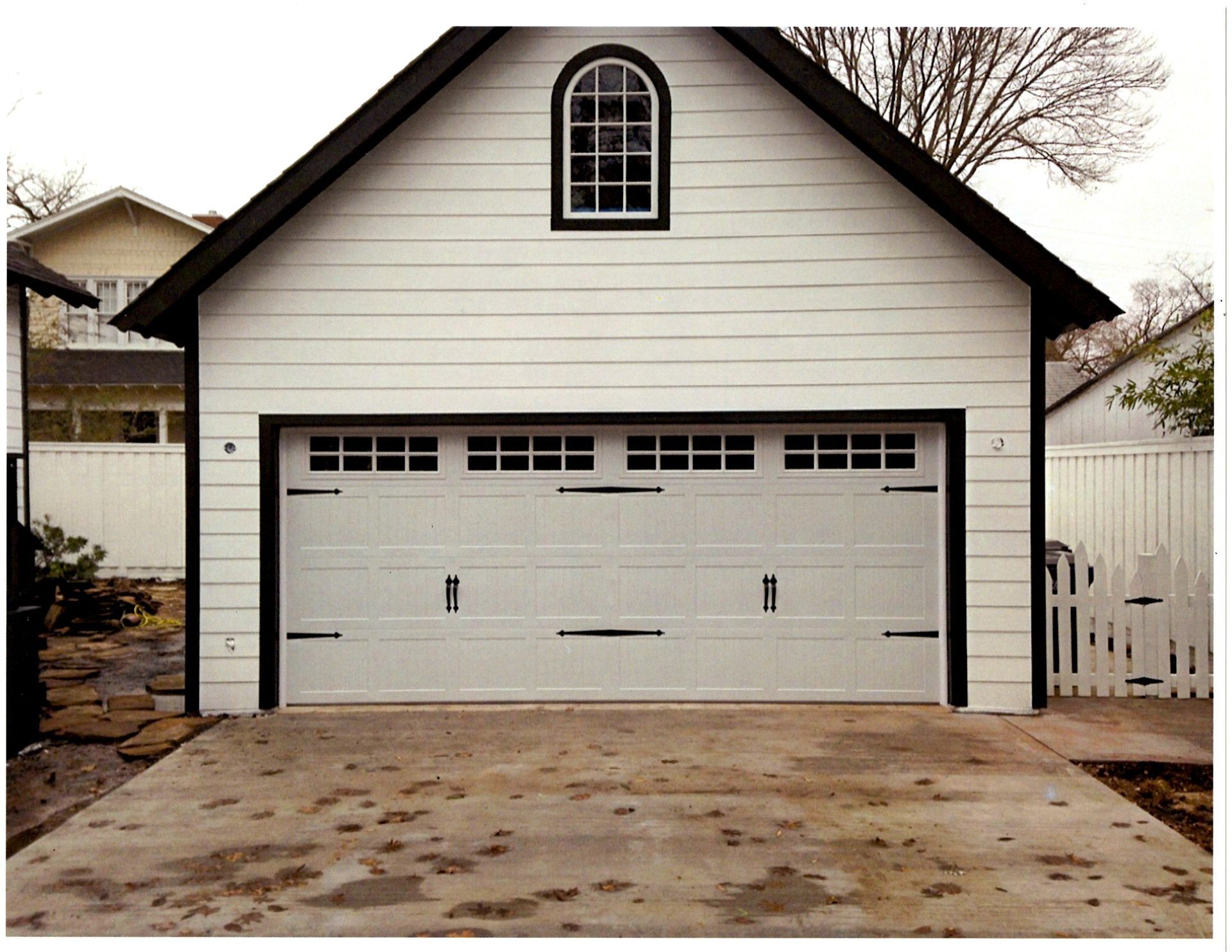 A white garage with a window on top of it