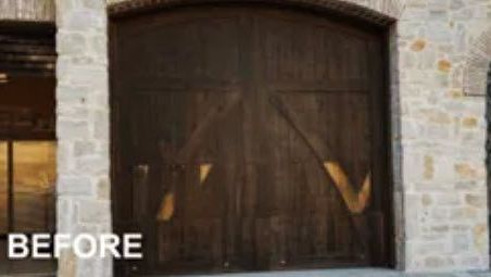 A Before Picture of A Wooden Garage Door on A Stone Building.