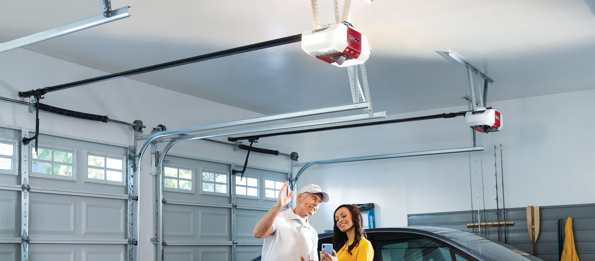 A garage door expert professional showing details to a client.