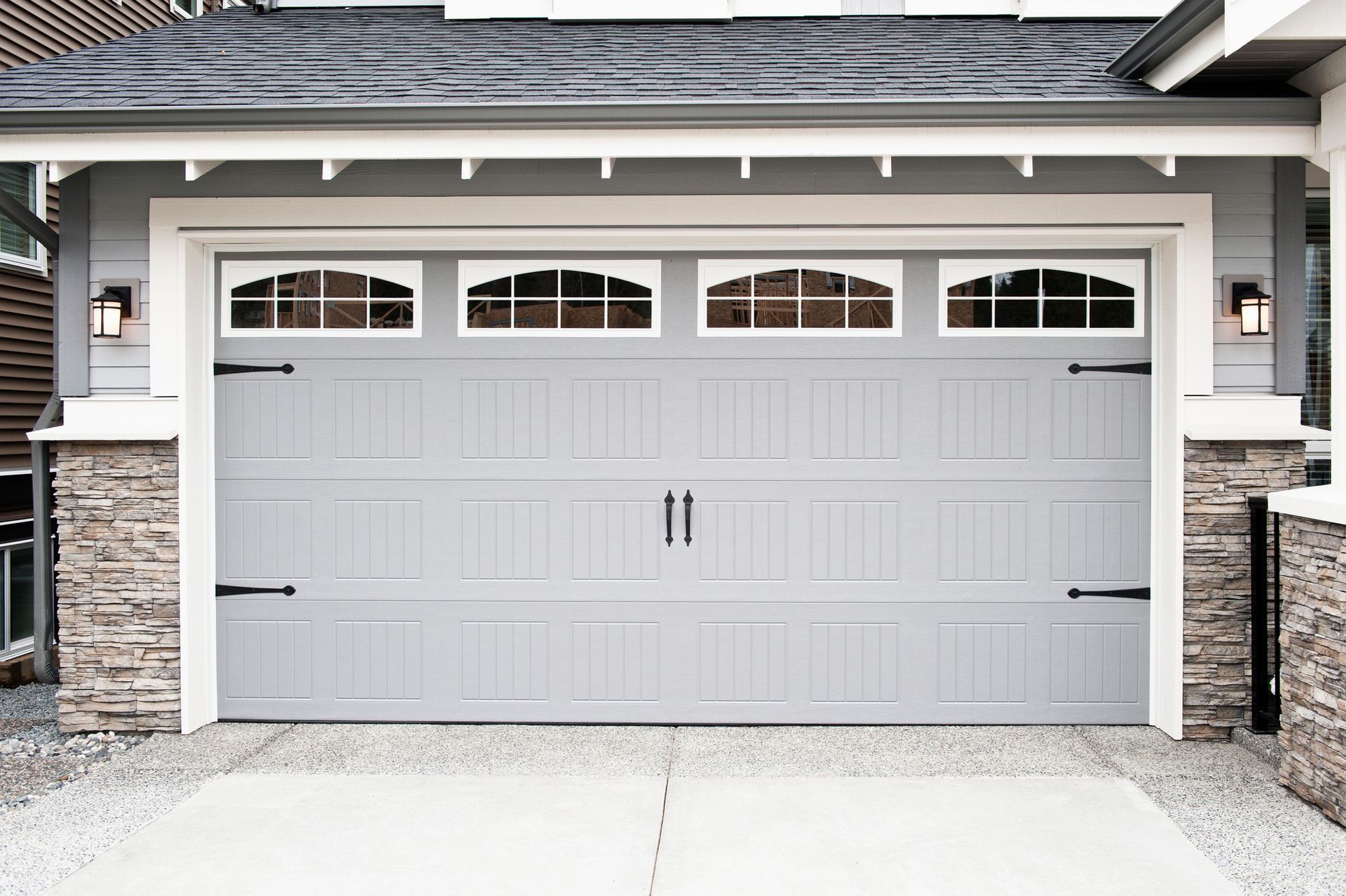 View of a beautiful, gray garage door, showcasing custom garage door installation. View of a beautiful, gray garage door, showcasing custom garage door installation.