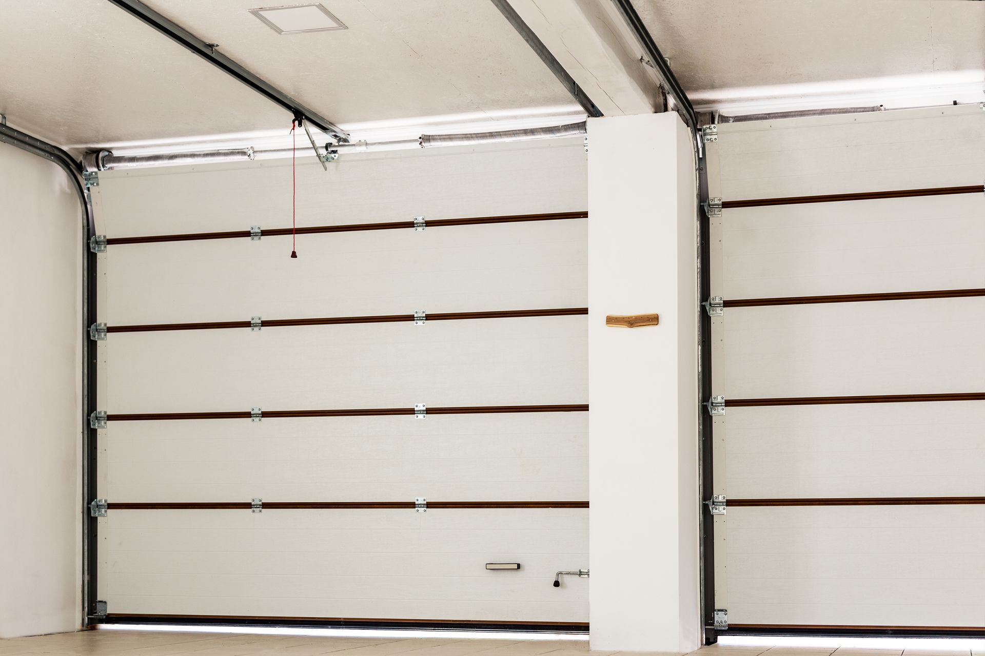 Double empty indoor garage space, showcasing professional garage door services for homes.