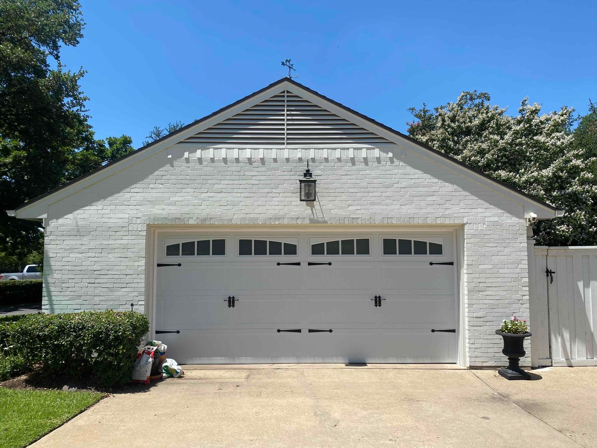 A white garage with a roof that has a cross on it